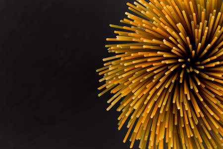 Bunch of raw italian pasta with vegetable dye of spinach, paprika and carrotの写真素材