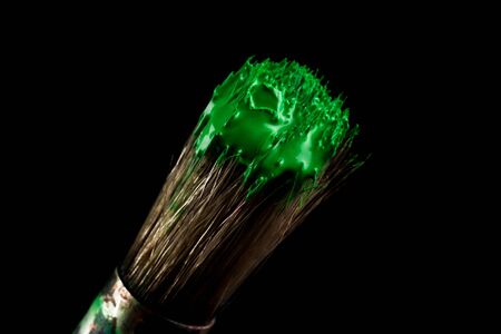 paint brush painting with green color on black backgroundの写真素材