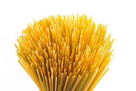 Bunch of raw italian pasta with vegetable dye of spinach, paprika and carrotの写真素材