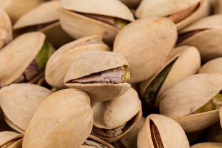 Pistachio nuts arranges as background close upの写真素材