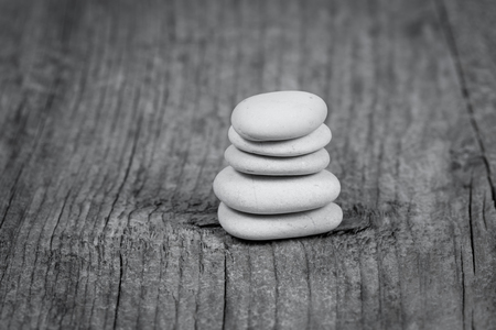 Pyramid of zen stones on a wooden boardの写真素材