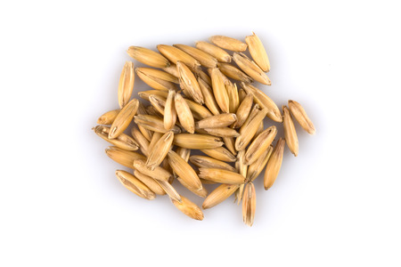pile of organic oat grains isolated on white backgroundの写真素材