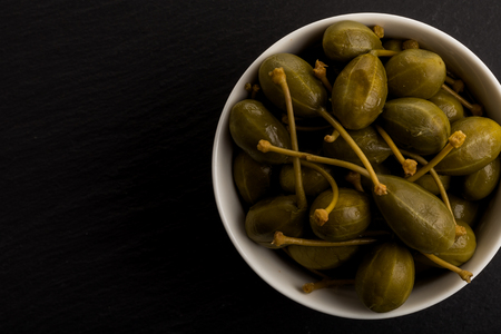 Bowl of canned capers on a dark backgroundの写真素材