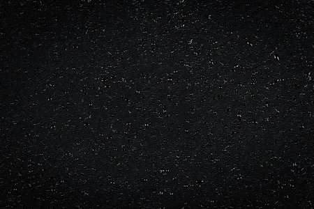 Water drops on dark stone surface texture backgroundの写真素材