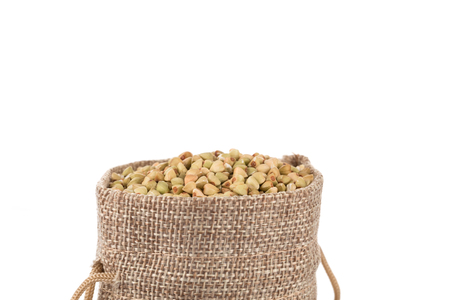 organic bio buckwheat raw in a hessian sack on whiteの写真素材