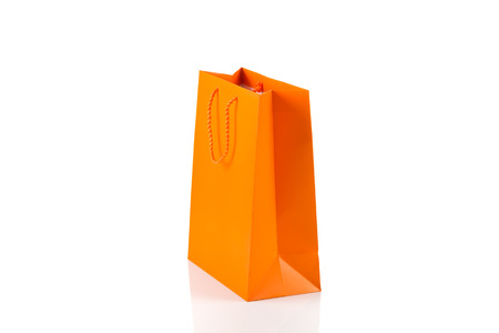 Orange paper bag isolated on whiteの写真素材