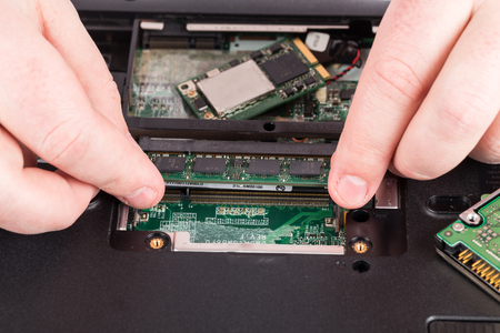 Close-up Of Technician Repairing Laptop At Deskの写真素材
