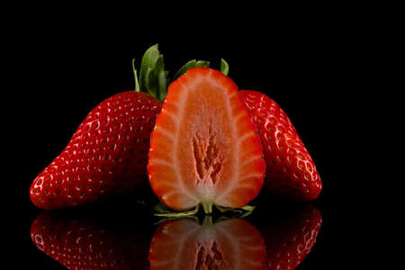 Red ripe strawberry fruits on a dark backgroundの写真素材