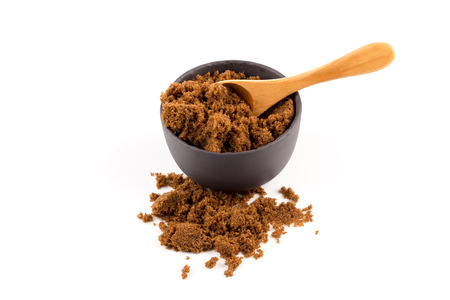 brown muscovado sugar in bowl isolated on white backgroundの写真素材