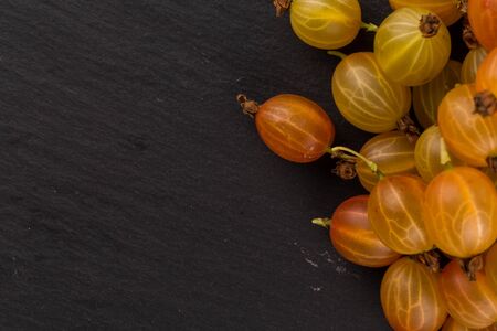 Fresh juicy gooseberry on stone dark backgroundの写真素材