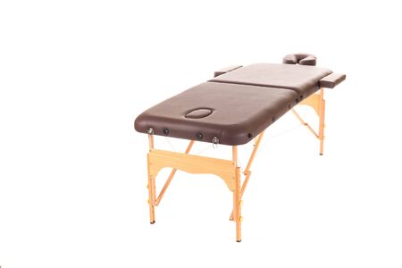 Massage Table from leather and wood isolated on a white backgroundの写真素材