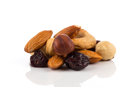 Mix nuts, dry fruits and grapes on a white backgroundの写真素材