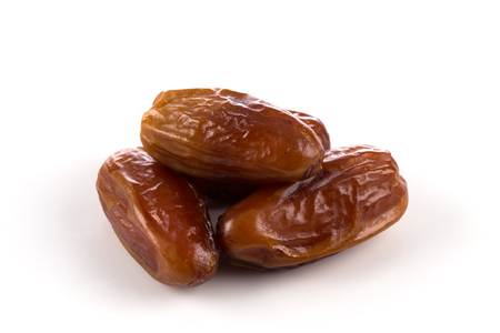 pile of dates fruits isolated on a white backgroundの写真素材