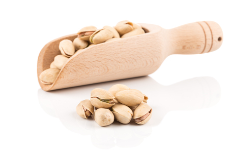 pistachio nut in scoop close up on white background isolatedの写真素材