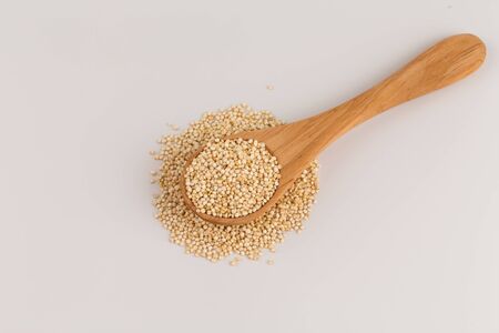 Pile of grain quinoa seeds in spoon isolated over the white backgroundの写真素材