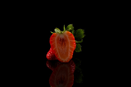 Red ripe strawberry fruits on a dark backgroundの写真素材
