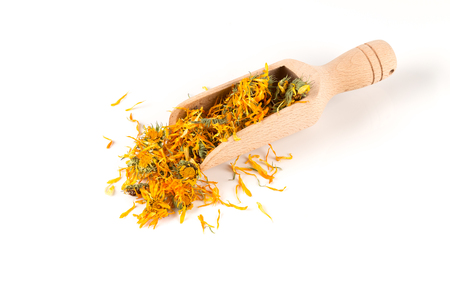 Calendula flowewr tea for infusion in wooden scoop on white backgroundの写真素材
