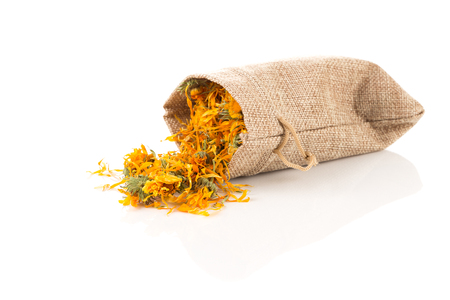 Calendula flowewr tea for infusion in sack on white backgroundの写真素材