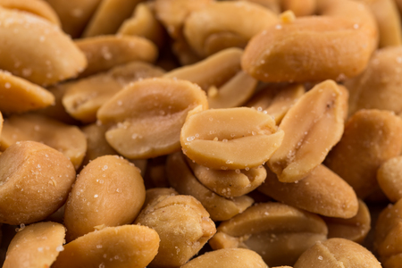 Close-up of a large amount of peeled salted peanuts in a basket