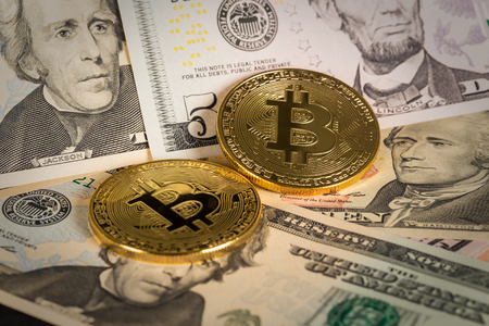 golden bitcoin digital money coin on us paper dollars bill close upの写真素材