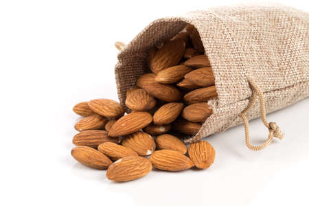 Sack of almonds nuts on a white backgroundの写真素材