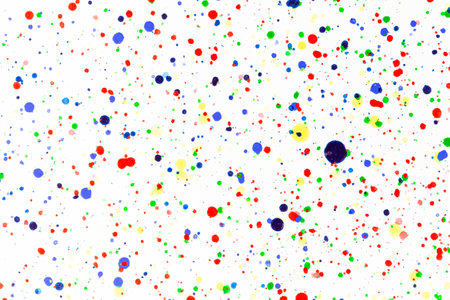 Colorful ink splashes. Paint splatters on bright material. Multi color dots. Watercolor on white...