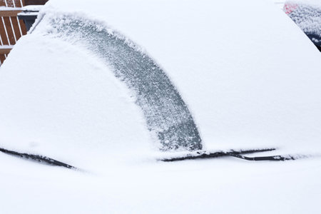 cleaning snow from the car in the winterの写真素材