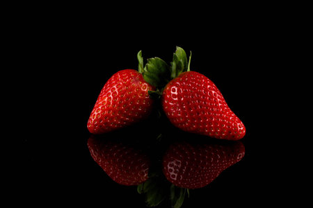 Red ripe strawberry fruits on a dark backgroundの写真素材