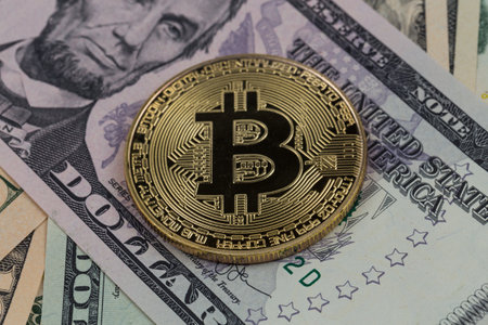 Golden bitcoin coin on a paper dollars money. Virtual  crypto currency. currency.