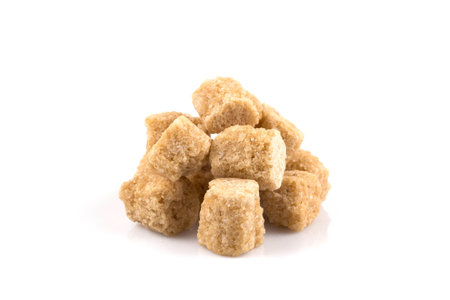 Brown cane sugar cubes  on white backgroundの写真素材