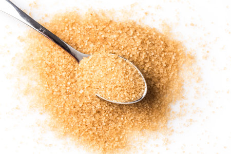 brown sugar in a spoon on white backgroundの写真素材