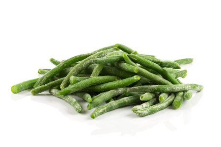 Frozen cut green beans vegetable in a bowl, isolated on whiteの写真素材