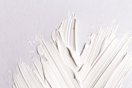 Hand made oil paint brush stroke splash over the white paper as a design element of a backdropの写真素材