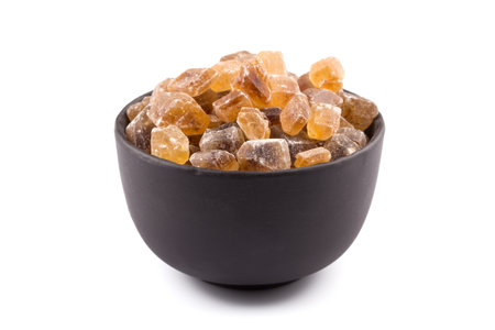 cane sugar in a bowl on a white backgroundの写真素材