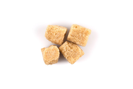 Brown cane sugar cubes  on white backgroundの写真素材