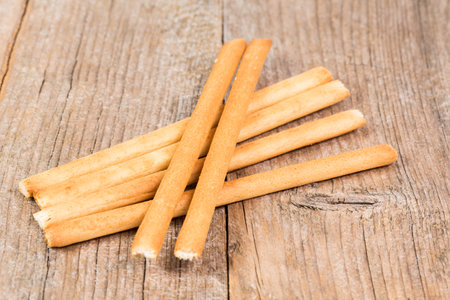 bread sticks grissini on rustic wooden backgroundの写真素材