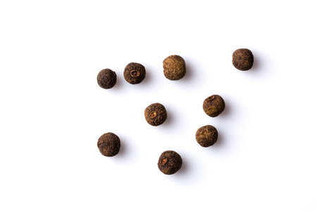 Large black pepper corns isolated on white background
