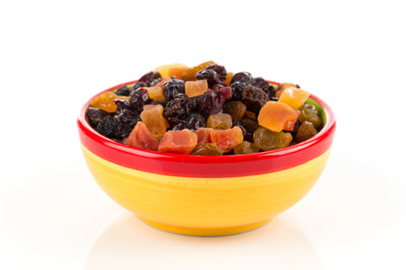 Mix variety of dried fruit in bowl over white backgroundの写真素材