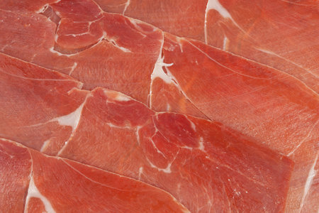 Red ham prosciutto sliced as a backgroundの写真素材