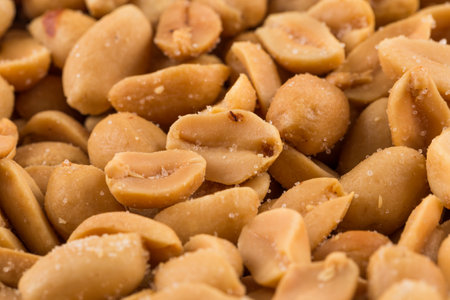 Close-up of a large amount of peeled salted peanuts in a basketの写真素材