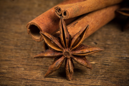 Close up of cinnamon sticks and star anise on rustic wood backgroundの写真素材
