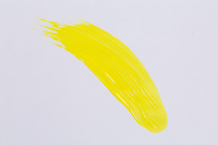 Yellow paint on white paper for background textureの写真素材