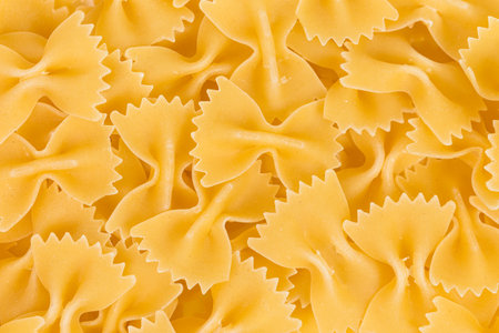 Close up of uncooked farfalle pasta as a backgroundの写真素材