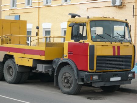 red-yellow emergency truck on asphalt road  