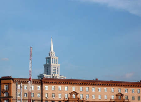 old house and modern capstan at dry sunny dayの写真素材