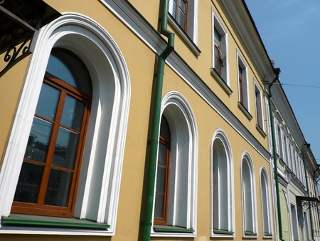 old yellow building with green storm-down pipe at day