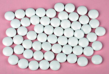 white pill on pink backgroundの写真素材