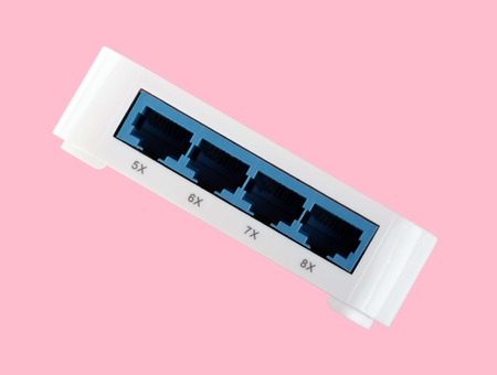 White 8 Port Plastic Ethernet Switch isolated on pink background at dry dayの写真素材