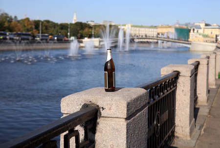 bottle on river fenceの写真素材