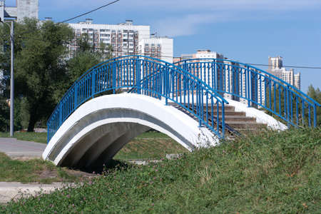 bridge over pond in park at dry sunny summer dayの写真素材